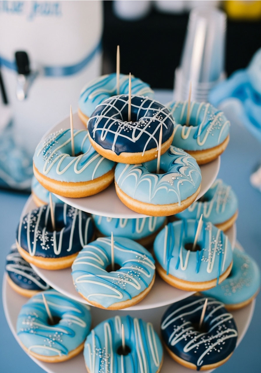 Marble blue glazed donuts with silver sprinkles on tiered stand for denim baby shower dessert table, unique sweet treats for party guests