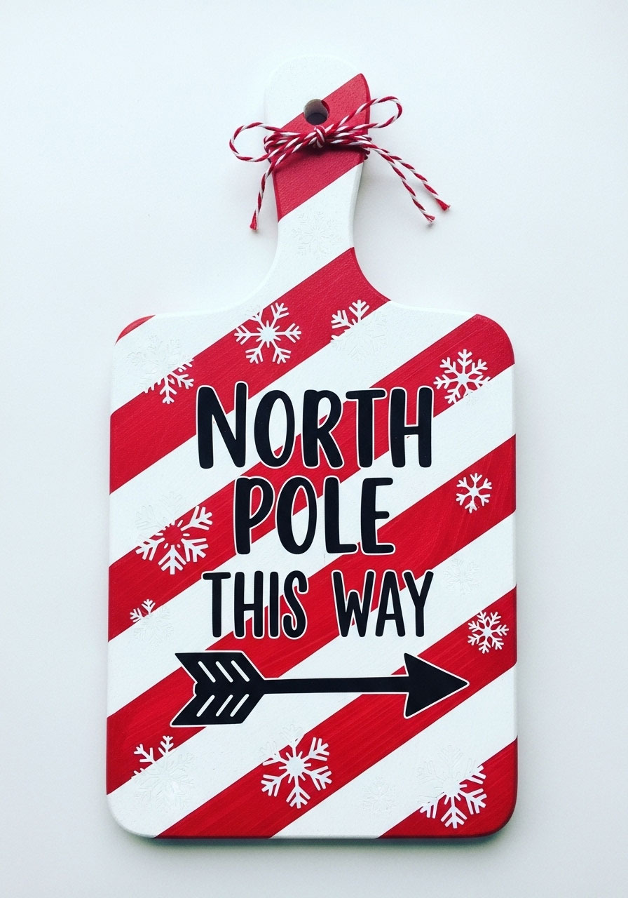 North Pole directional sign Dollar Tree cutting board with candy cane stripes and snowflake decorations for whimsical Christmas decor