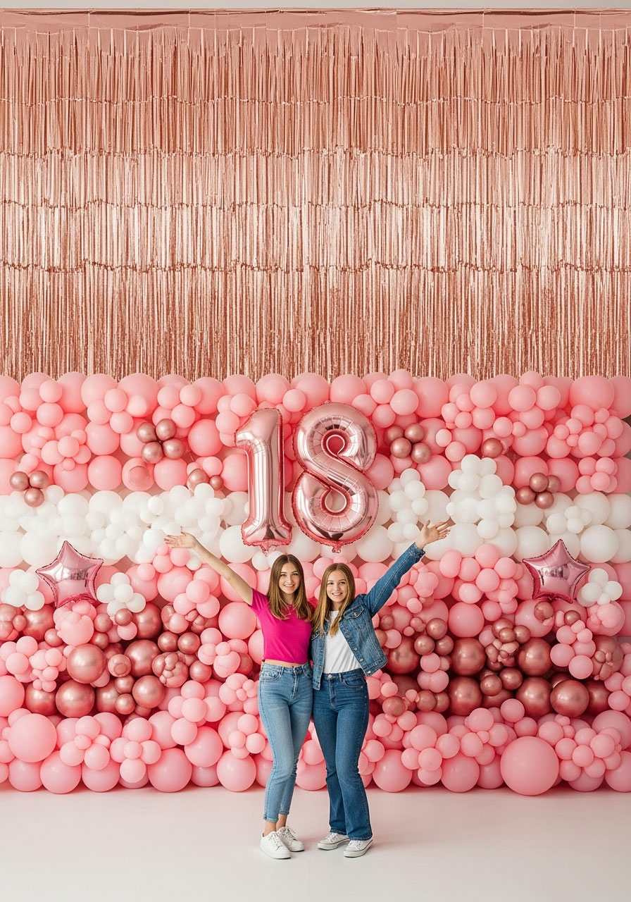 Pink and rose gold balloon stack with fringe curtain backdrop for 18th birthday party photos