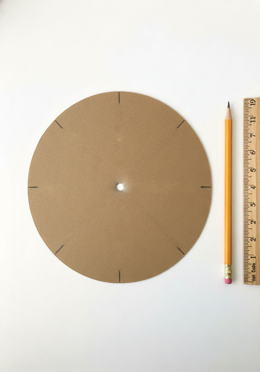 Cardboard circle with 8 evenly spaced lines marked for creating notches in DIY loom bracelet