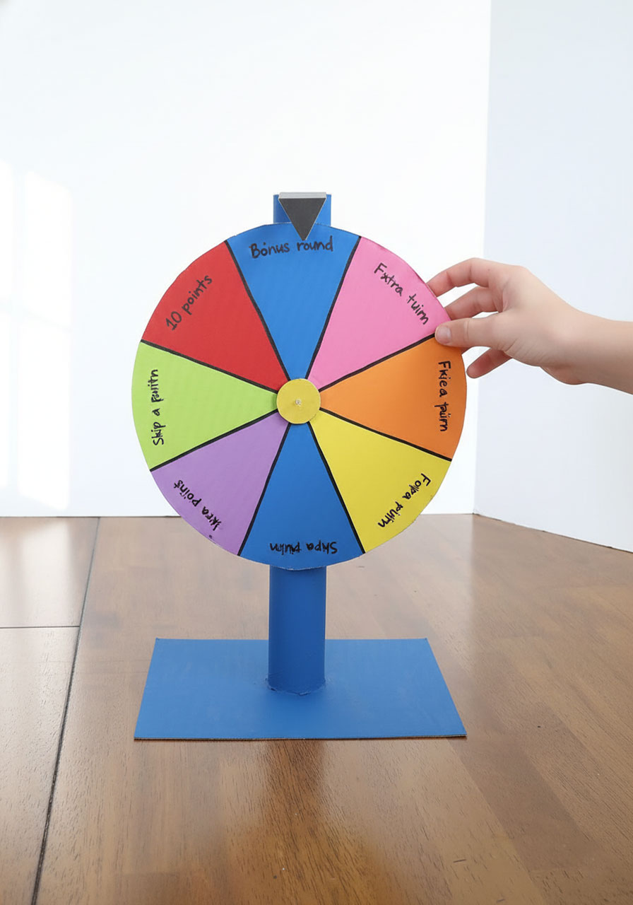 Colorful DIY cardboard prize wheel spinner in motion with eight painted wedges and arrow pointer for kids carnival party game