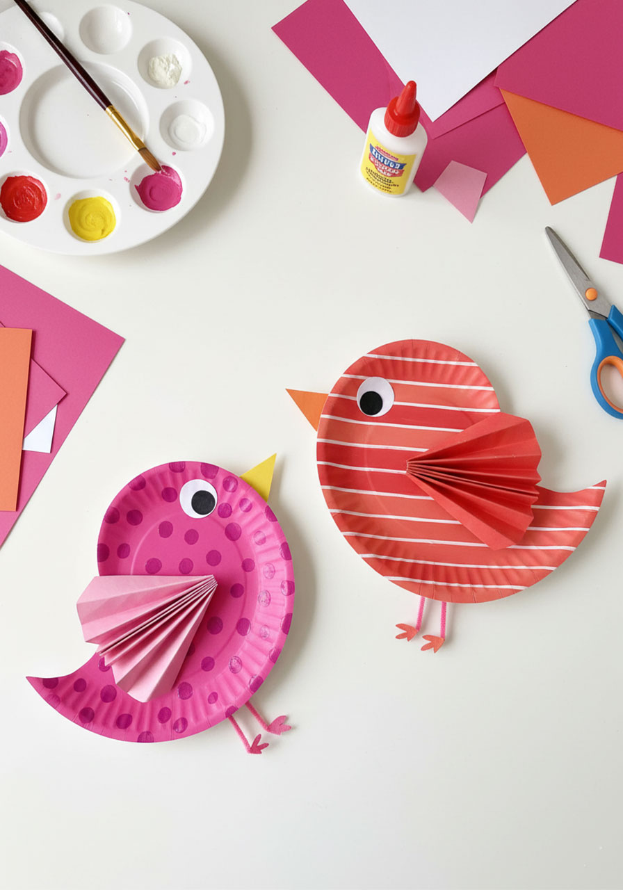 Two adorable love birds made from painted paper plates with accordion-folded heart wings and pipe cleaner legs