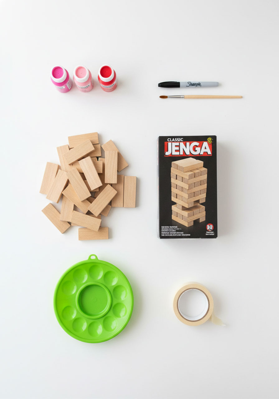All materials needed to create DIY Valentine's Day date night Jenga including paint, blocks, and markers