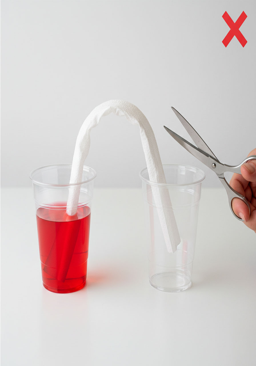 Common mistake in walking water experiment showing paper towel bridge too high creating slow water transfer