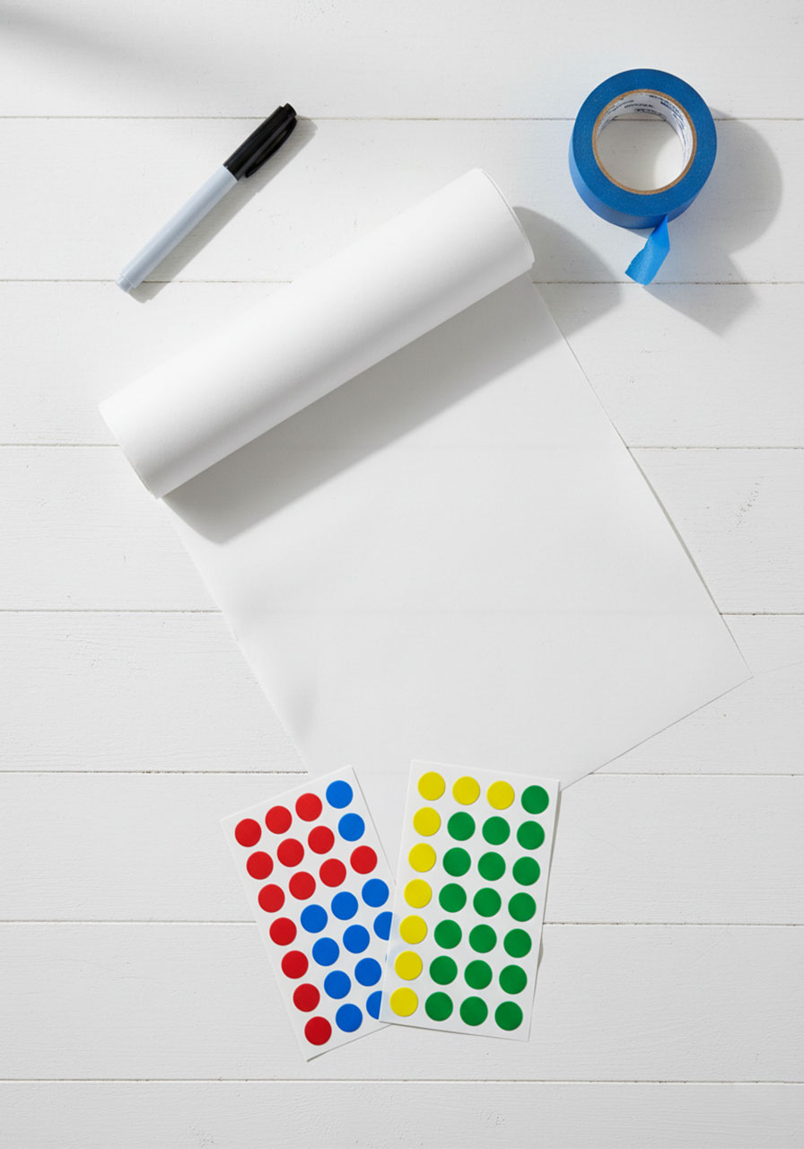 Materials needed for dot sticker addition activity — butcher paper, painter's tape, Sharpie marker, and colorful dot stickers