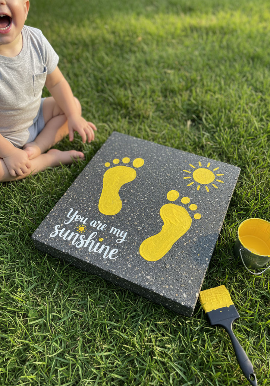 Concrete garden stepping stone with yellow child footprints and "You are my sunshine" text — DIY Mother's Day gift idea from kids for grandma's garden