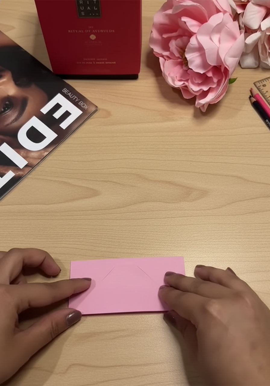 Step-by-step flat lay showing how to fold a 3D paper tulip for a DIY Mother's Day bouquet card, five stages from flat square to finished flower step1b