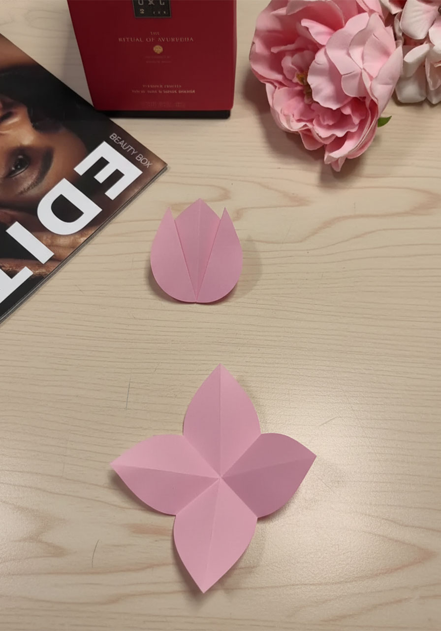 Step-by-step flat lay showing how to fold a 3D paper tulip for a DIY Mother's Day bouquet card, five stages from flat square to finished flower step1f