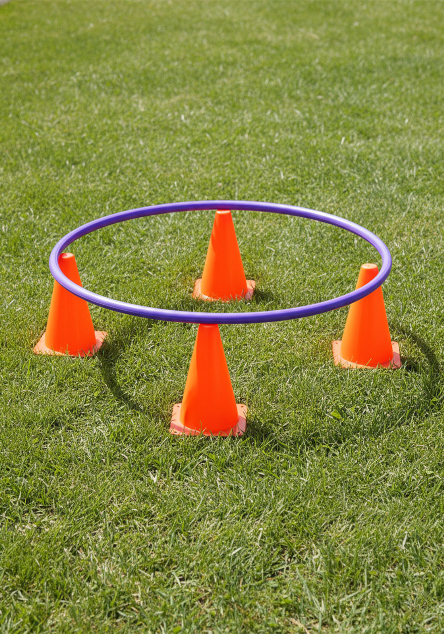 Hula hoop balanced on four orange cones for the Rabbit Hole gross motor game setup