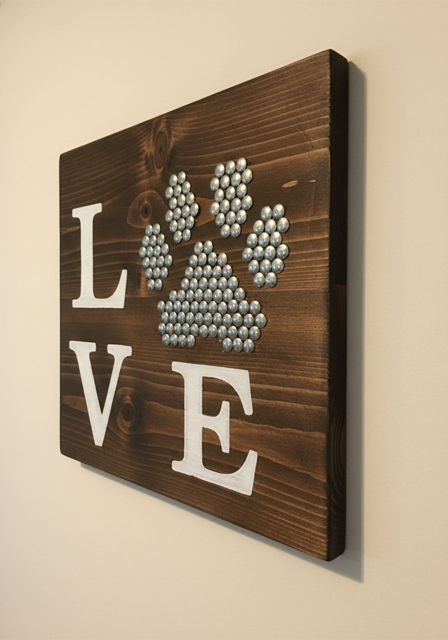 Finished rustic LOVE sign with thumbtack paw print on dark espresso-stained wood board