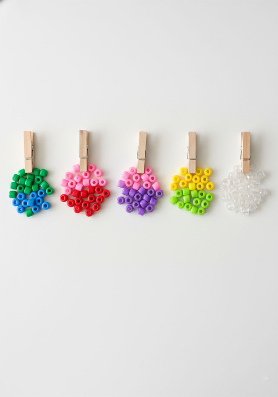 Five color combination options for beaded pipe cleaner butterflies showing blue green, pink red, purple orange, yellow green, and clear bead groupings