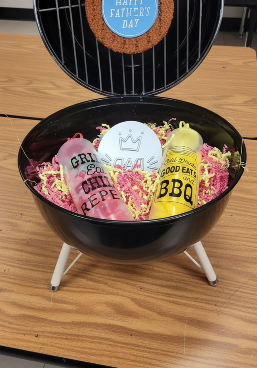 DIY mini kettle grill Father's Day gift basket open reveal moment showing the burger grate display, Happy Father's Day message, and BBQ-themed gifts inside the bowl