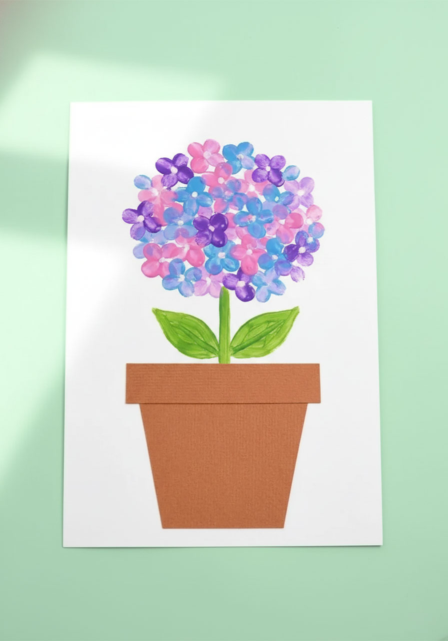 Finished DIY Mother's Day art showing dotted pastel hydrangea painting with cotton swab stamped lavender pink and blue flowers on white cardstock