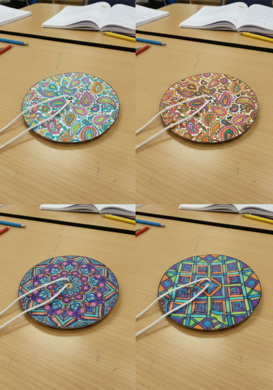 Four completed DIY paper spinner discs showing different design ideas