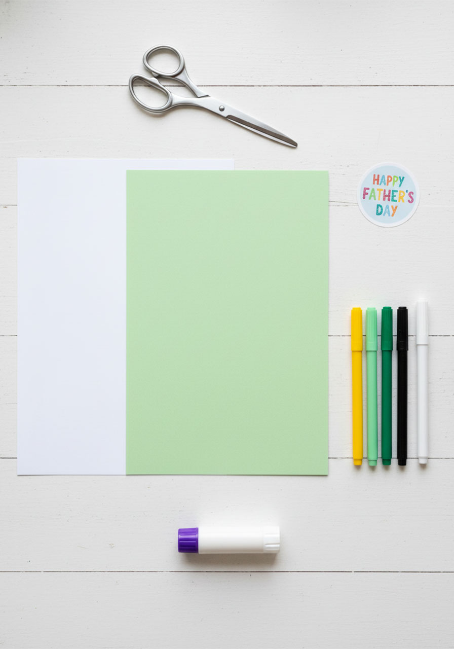 Craft supplies needed for Father's Day pop-up card including cardstock, markers, scissors, and glue stick