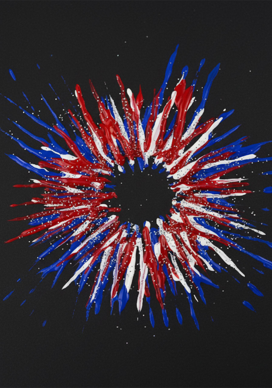 Close-up macro detail of a completed fork painted firework in red white and blue with silver glitter on black cardstock