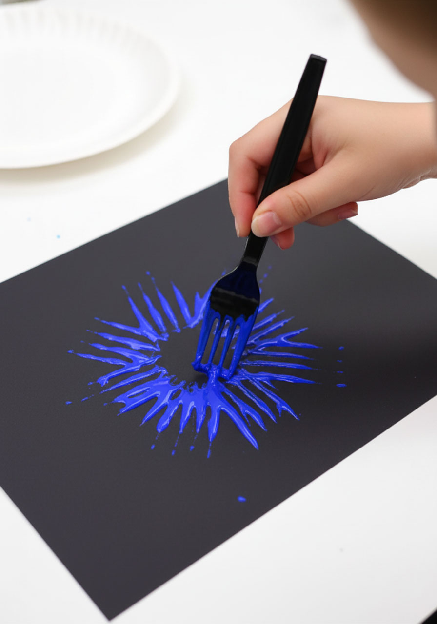 Child stamping blue paint with a fork onto black cardstock paper to create a firework burst shape