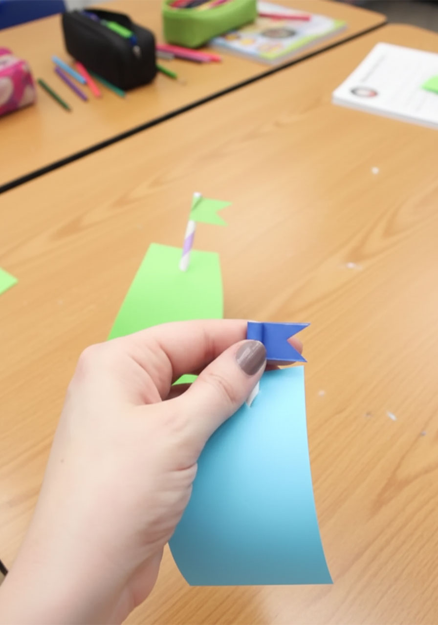 Making a washi tape pennant flag by cutting a V-notch at the top of a paper straw for a pool noodle boat step5b