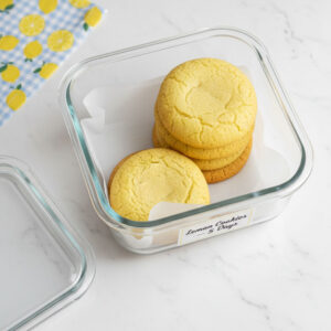 Sugar free lemon cookies stored in airtight container with parchment paper layers for freshness