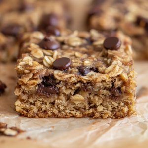 Close-up of a single banana oatmeal bar showing oat texture and melted chocolate chips