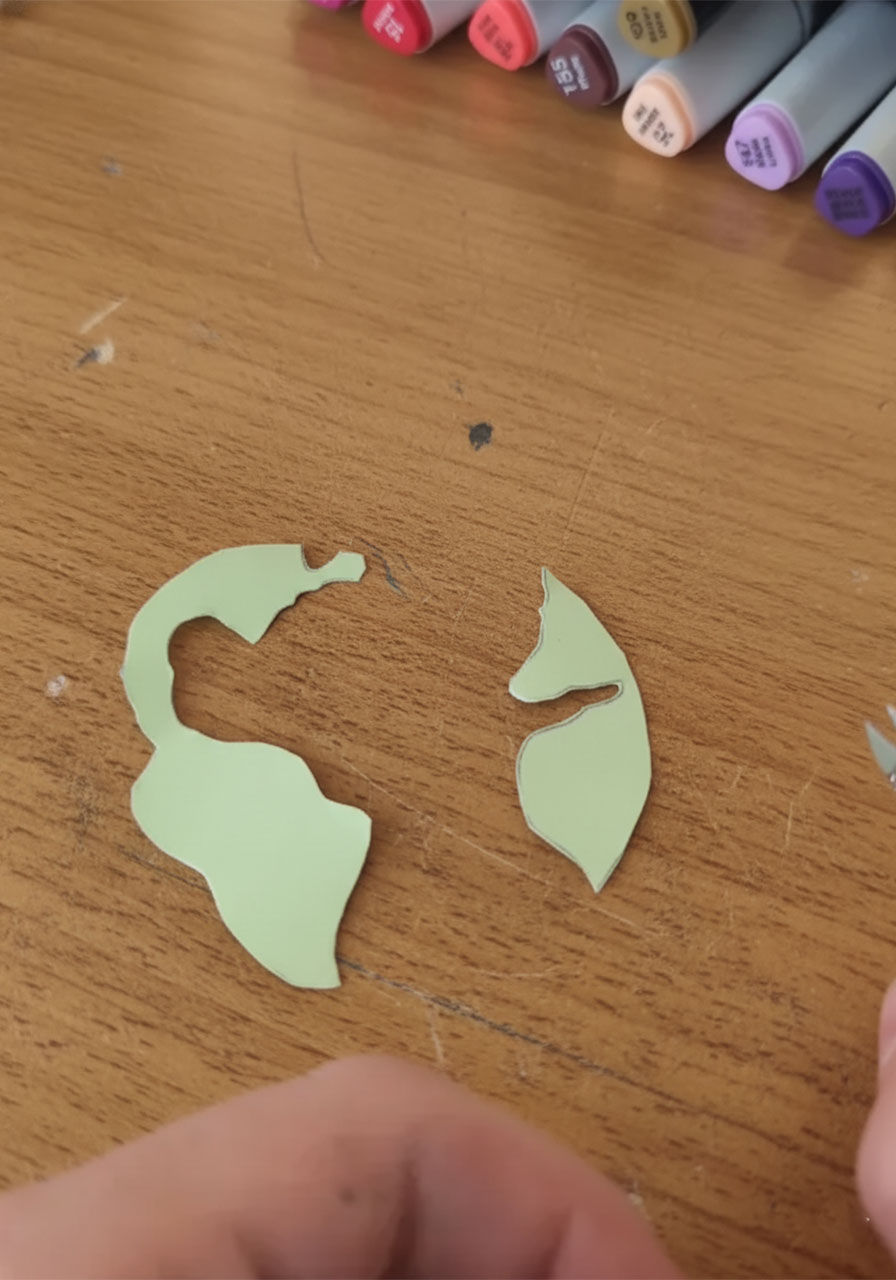 Cutting freehand green paper continent shapes to layer onto the 3D paper globe for the Father's Day card step4b