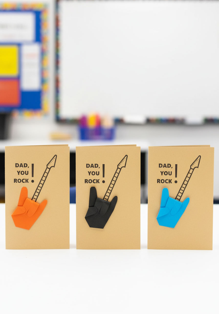 Three Dad Rocks handprint guitar Father's Day cards side by side in orange, black, and blue color variations