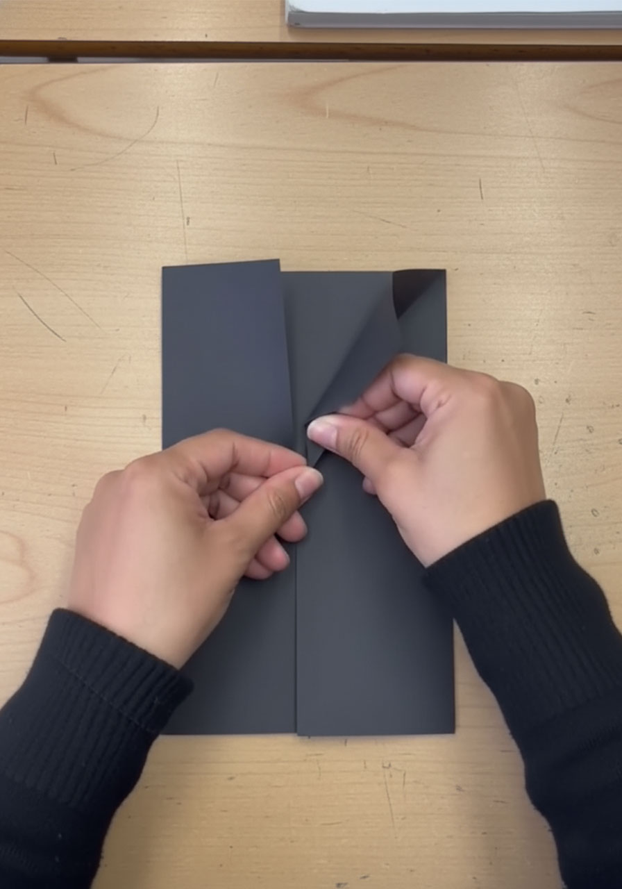 Folding lapels on black cardstock to create suit jacket collar shape for DIY tuxedo Father's Day card step 2a