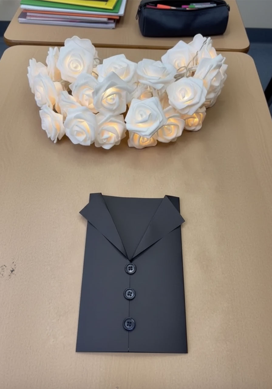 Gluing three black buttons onto tuxedo Father's Day card jacket front for step 7b