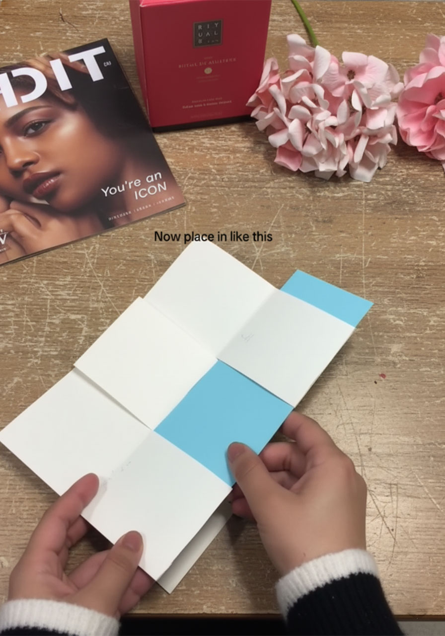 Weaving sky blue paper strips through white paper slits to create the checkerboard magic reveal pattern for the Father's Day flip card STEP4B
