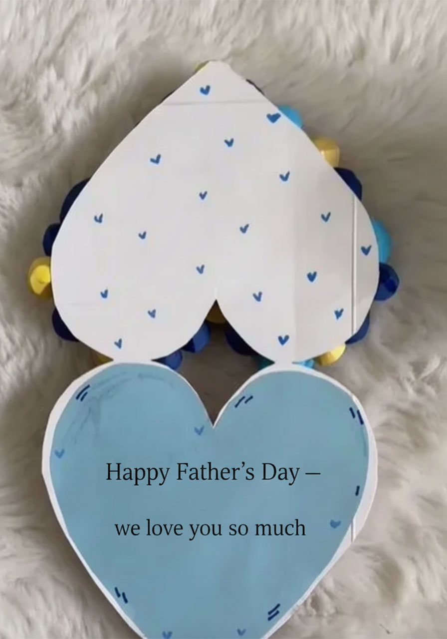 Hidden message card unfolded inside DIY paper rose heart bouquet showing handwritten Happy Father's Day note — secret message gift for dad