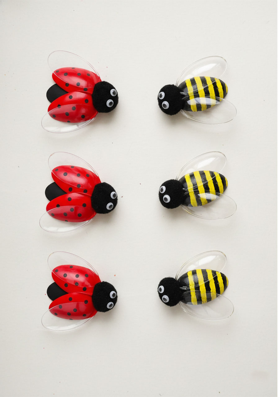 Finished plastic spoon bug craft showing red ladybugs and yellow bumblebees made from painted plastic spoons with googly eyes