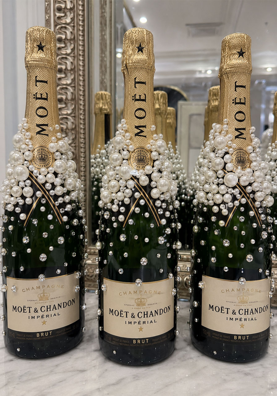 Bedazzled champagne bottles decorated with pearls and rhinestones for 18th birthday gift