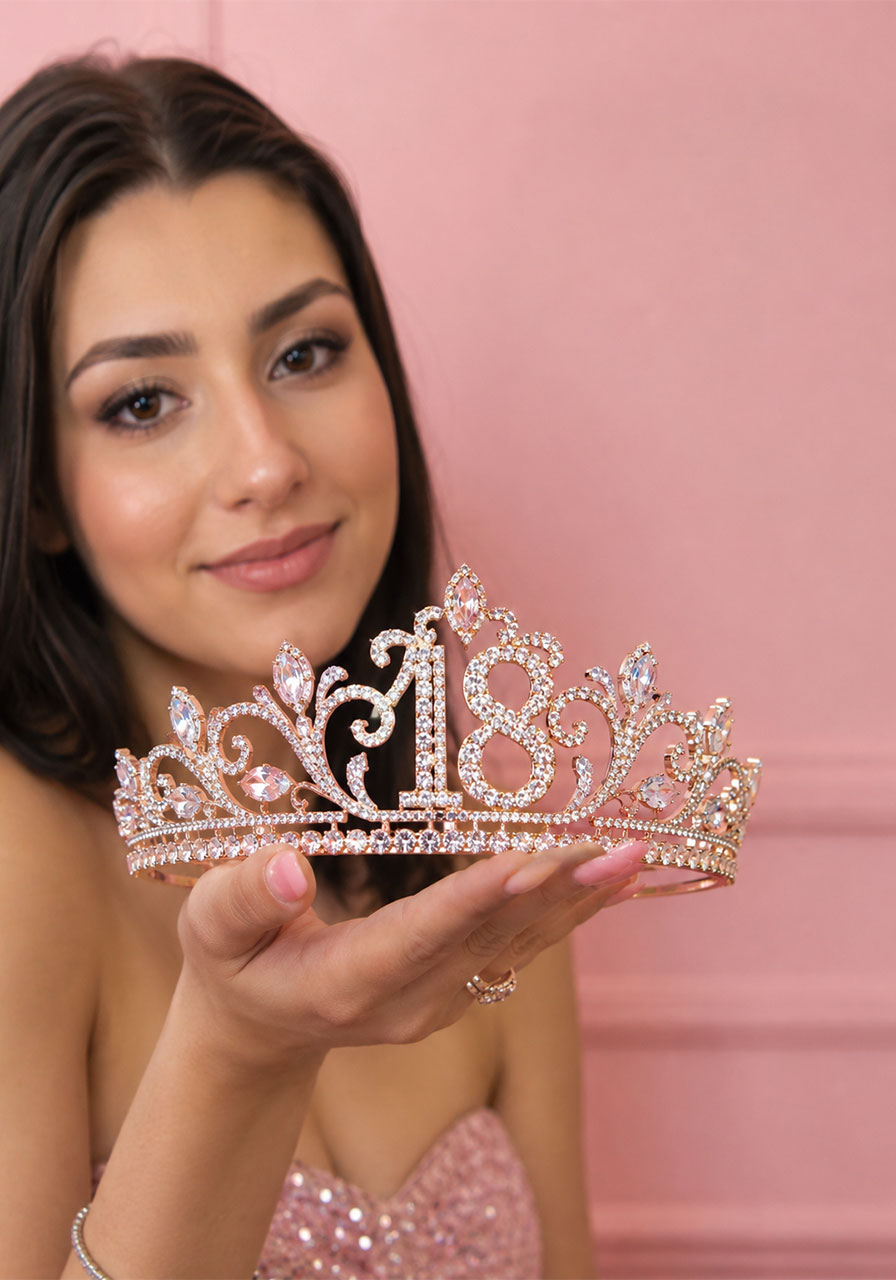 Rose gold rhinestone 18th birthday crown tiara held up against pink background