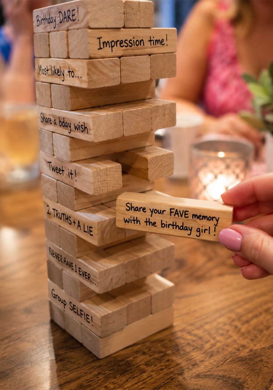 Memory Jenga game with handwritten prompts pulled mid-game at 18th birthday party