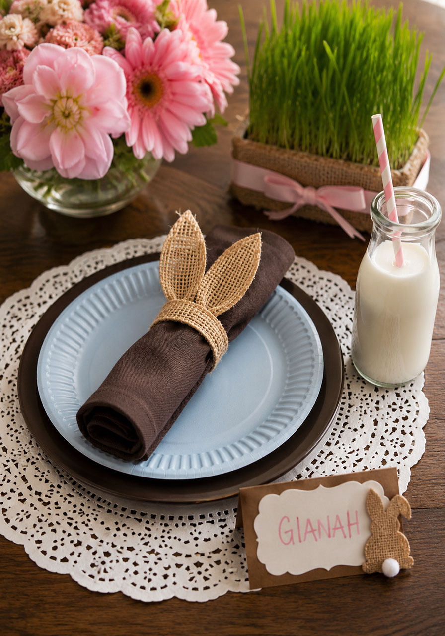 Elegant paper doily placemat with burlap bunny ear napkin ring at a bunny and butterfly birthday party table setting