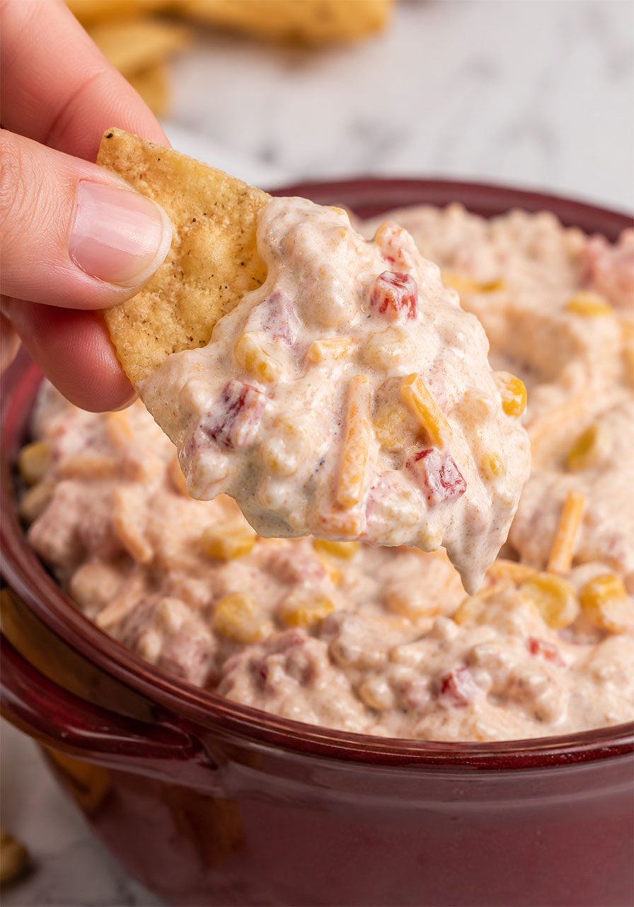 Close-up of tortilla chip loaded with creamy TikTok-style rotel ranch boat dip