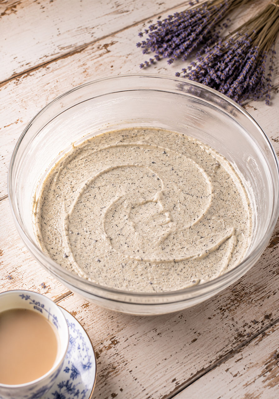 Earl Grey lavender cake batter in mixing bowl with visible tea leaf specks for London Fog cake