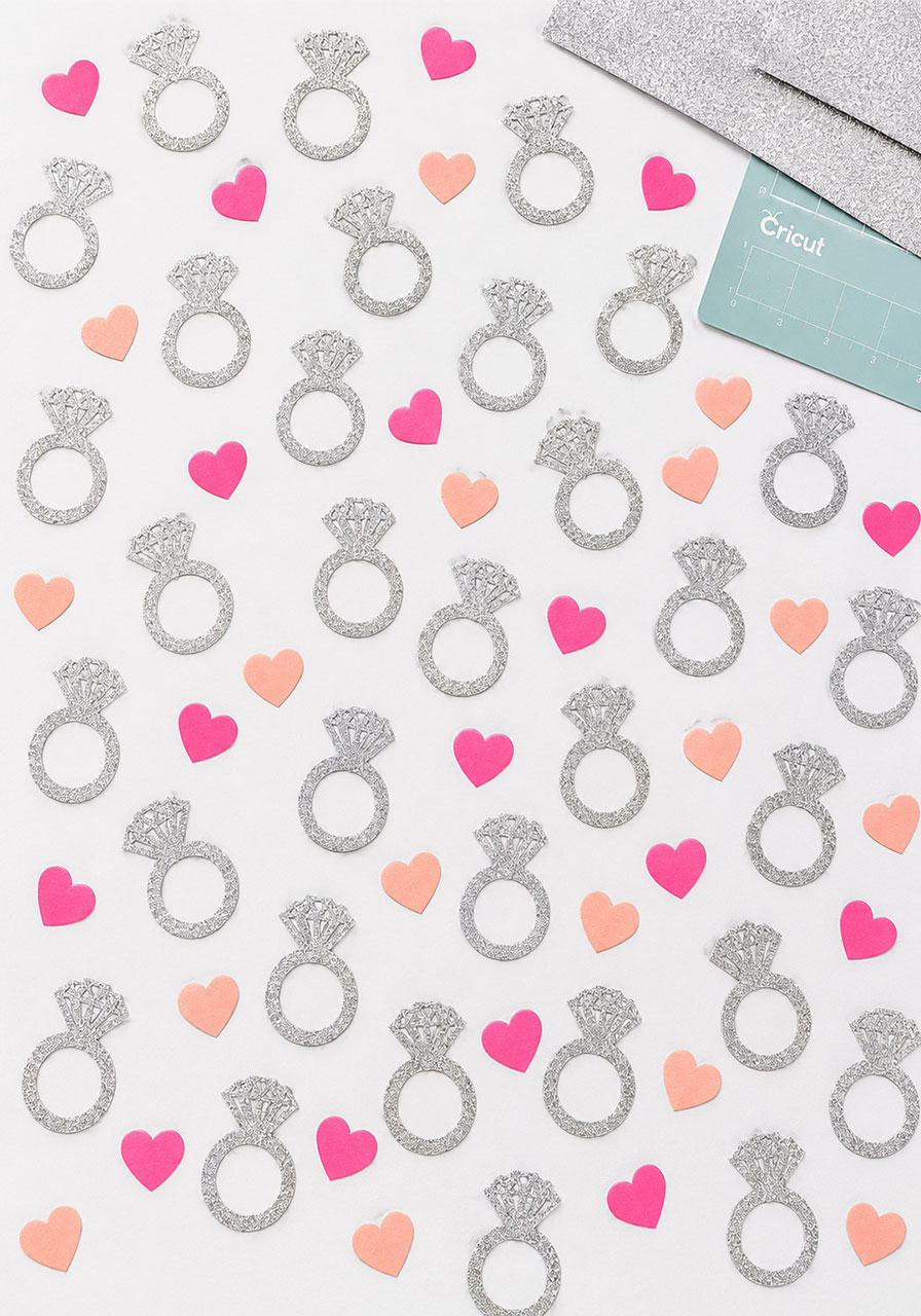 DIY engagement ring and heart confetti cut with Cricut from glitter cardstock — bridal shower table scatter decoration