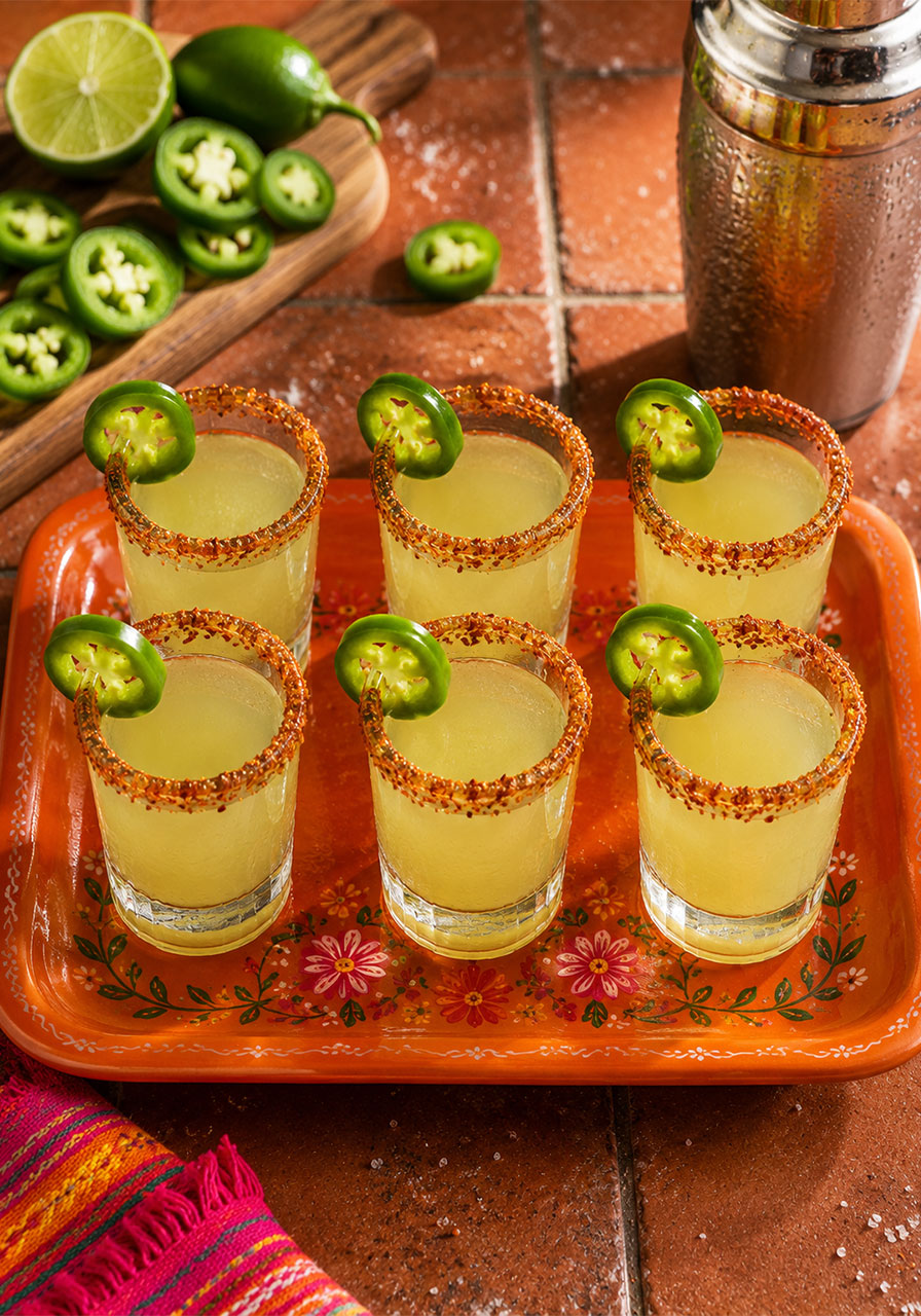 Spicy jalapeño margarita shots with Tajín rims and fresh jalapeño garnish for a Final Fiesta bachelorette party drink activity