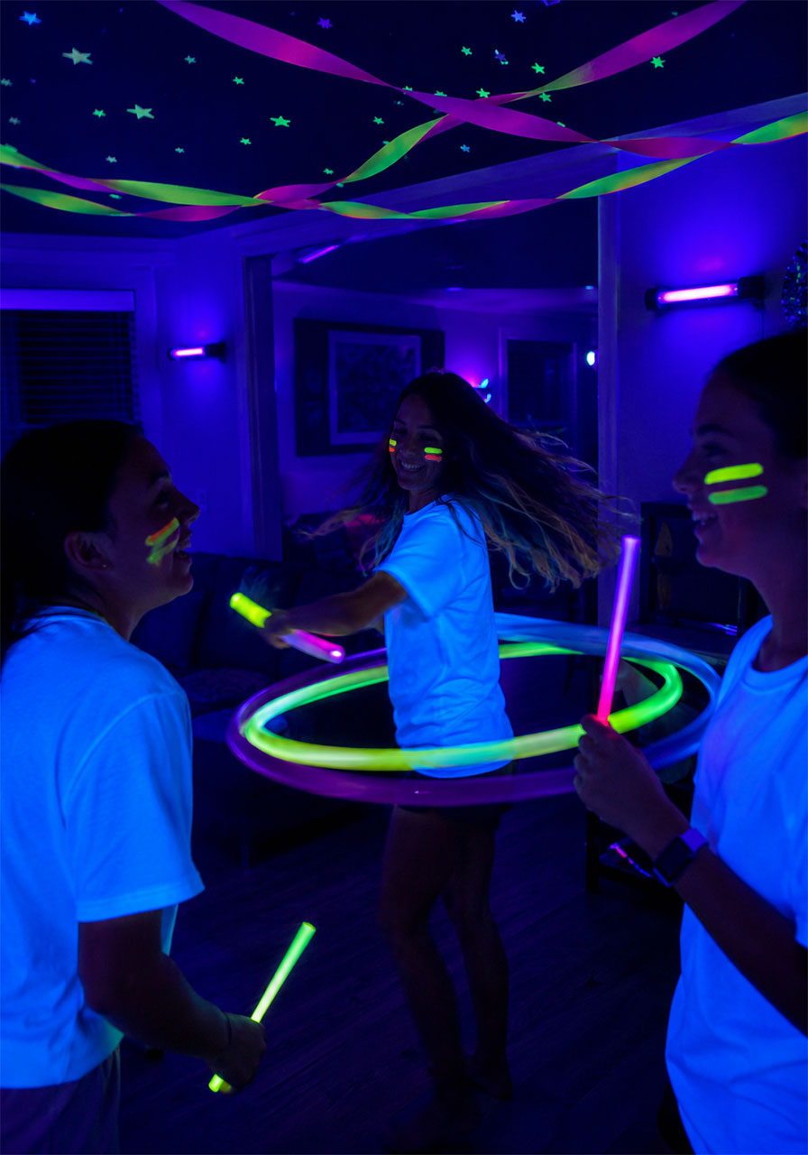 Glow in the dark birthday party with UV lights and neon face paint for 13-year-old teen girls