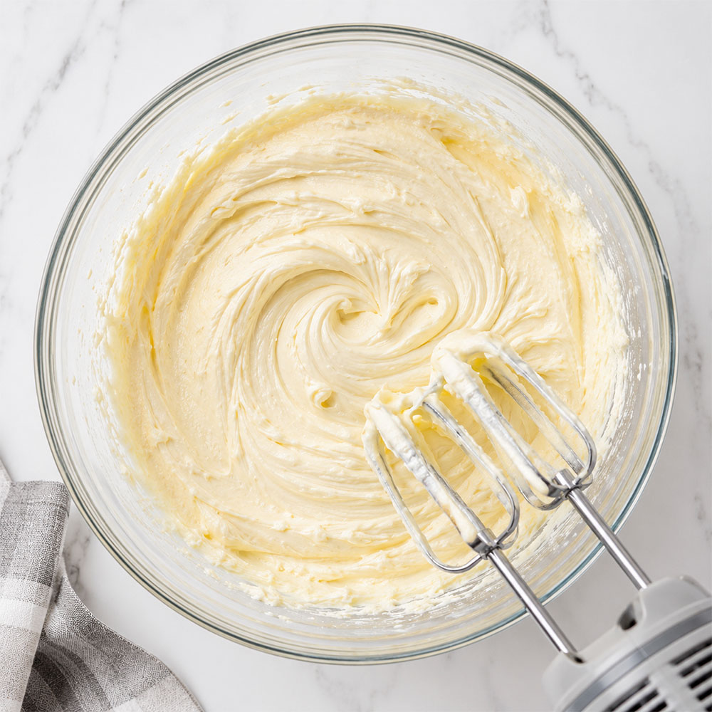 Cream cheese, butter, and powdered sugar mixed smooth for Golden Oreo Sand Pudding