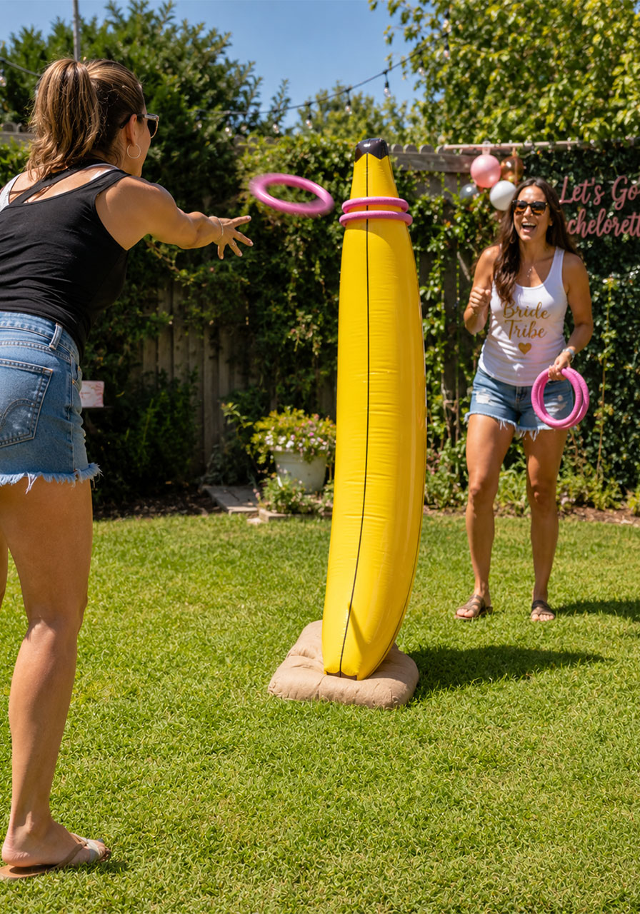 Friends playing inflatable banana ring toss outdoors at a bachelorette party