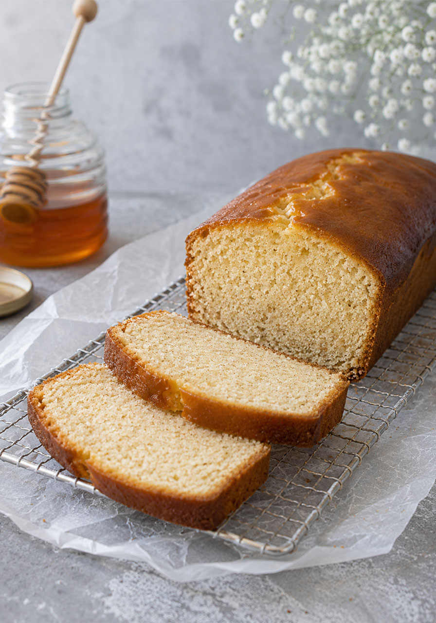 Sliced honey tea cake loaf showing soft moist crumb texture