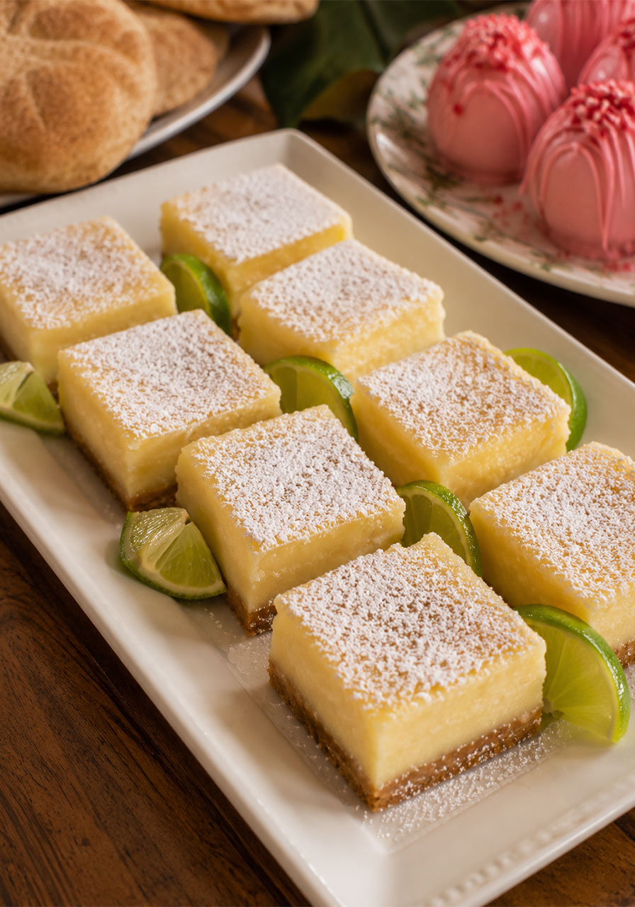 Key lime bars on a dessert tray with lime wedge garnish for a Key West party themed summer dessert spread