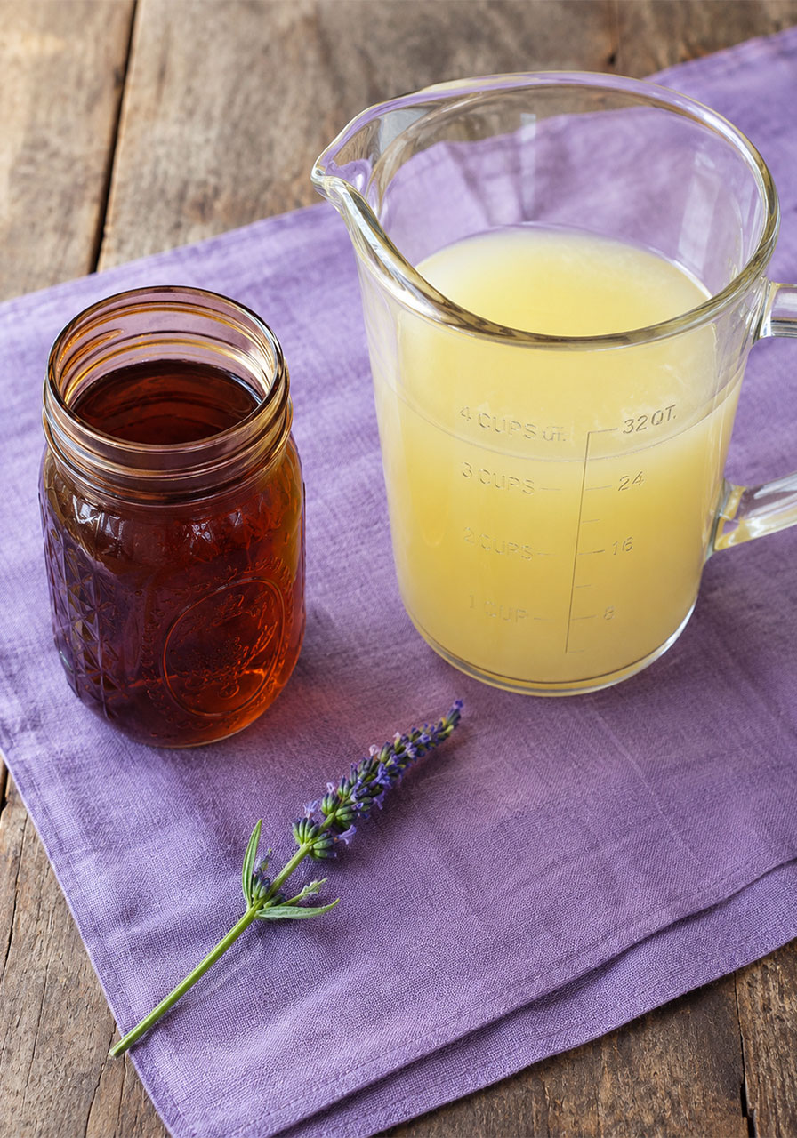 Lavender tea and lemonade concentrate side by side before mixing together