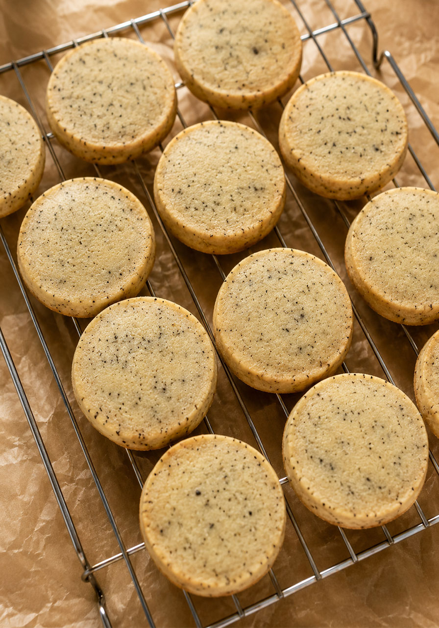 Freshly baked London Fog tea cookies cooling on a wire rack