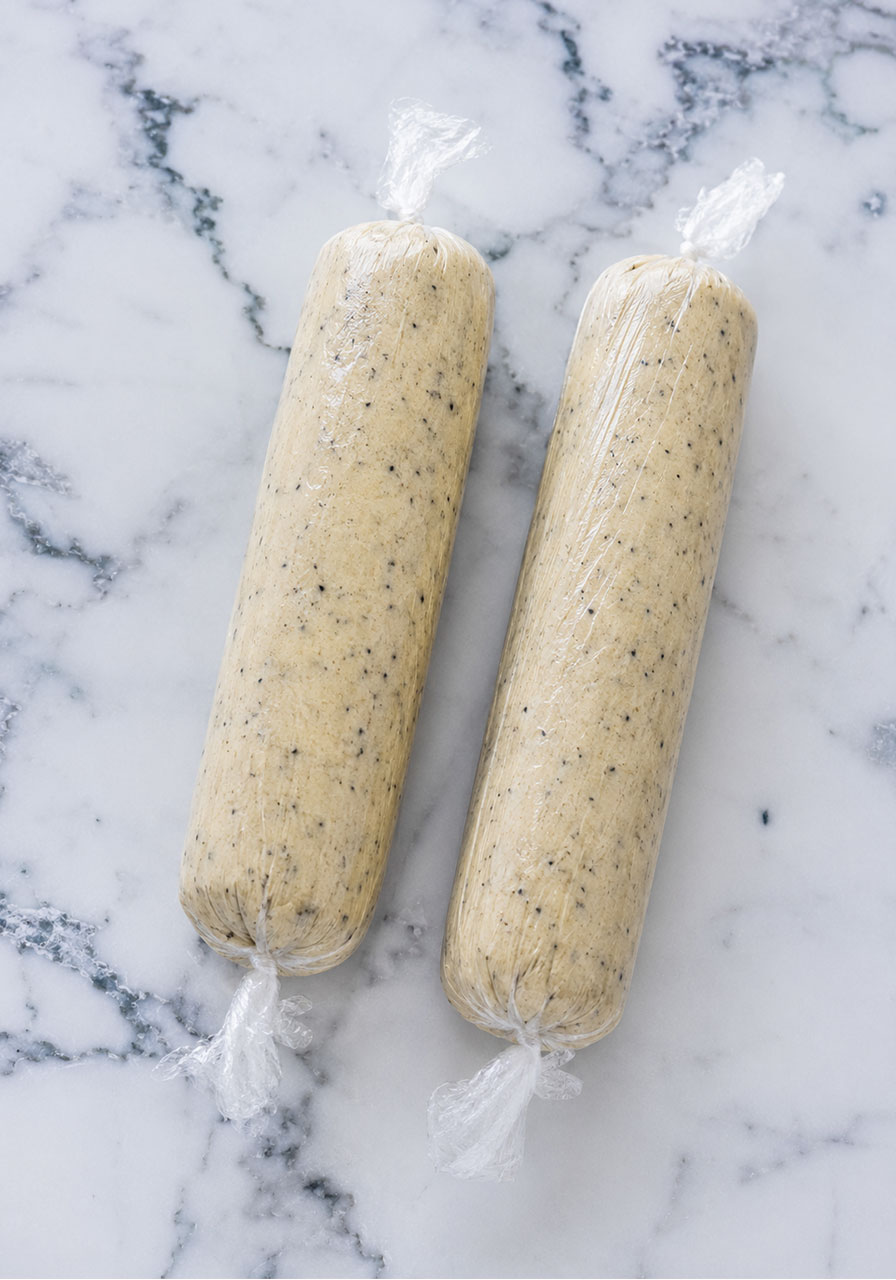 Two London Fog cookie dough logs wrapped in plastic before chilling