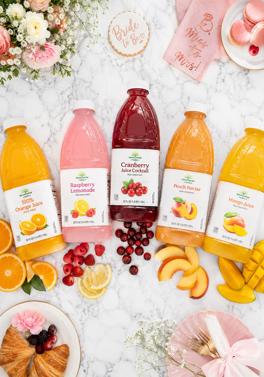 Five juice bottle varieties for a bridal shower mimosa bar — orange, cranberry, pink lemonade, peach, and mango