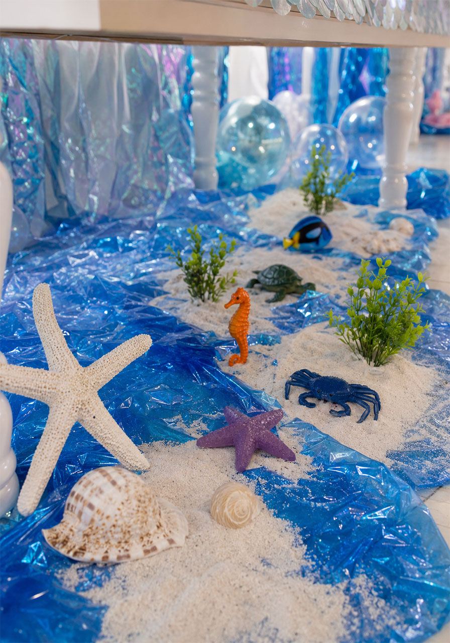 Ocean floor ground display with sand shells and sea creatures for an under the sea birthday party