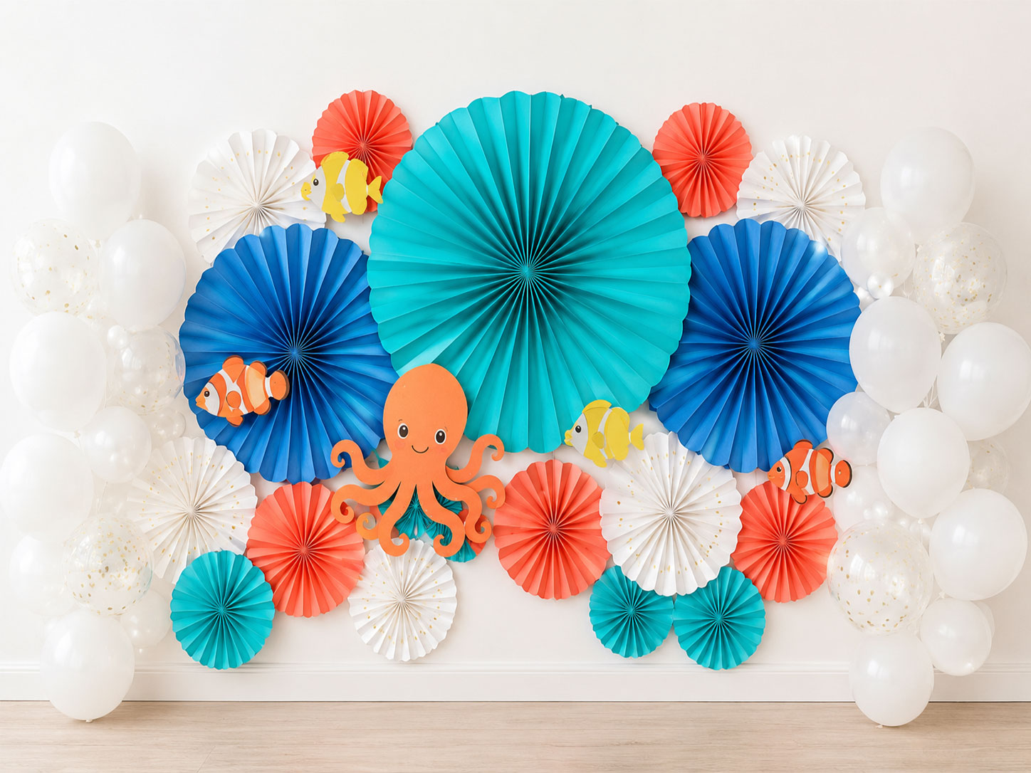 Blue teal and white paper fan wall decorations for an under the sea birthday party